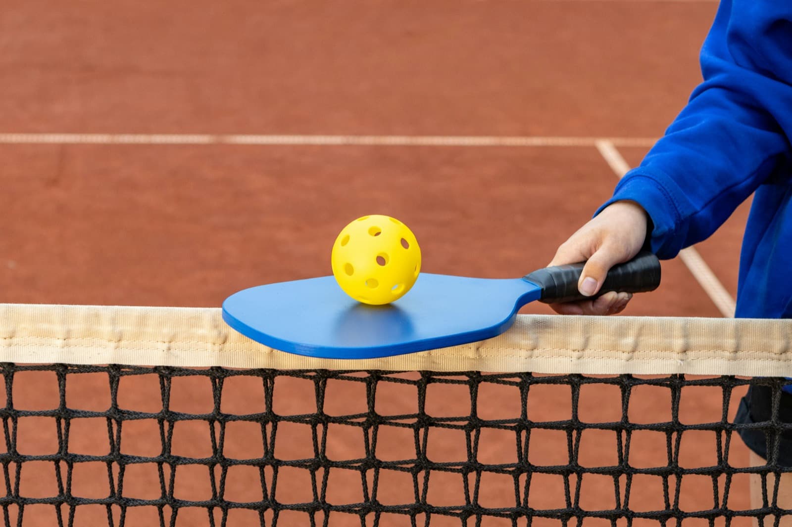 Beginner pickleball players on a Space Coast court